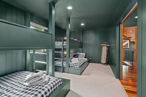 A bunk bed room with a built-in desk and a ladder. - Private Mountain Estate | Riverfront | Mt. Rainier (Packwood)