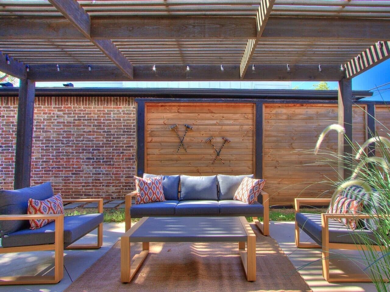An outdoor seating area with a sofa, chairs, and a coffee table.