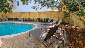 A swimming pool with lounge chairs and a brick patio. - Luxury Old Seagrove Retreat, Walk to Beach and Seaside, 3 King BRs, Private Heated Pool (Seagrove Beach)