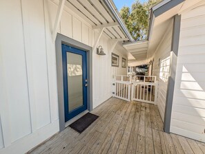 A wooden deck with a blue door and a white railing. - Luxury Old Seagrove Retreat, Walk to Beach / Seaside, Private Heated Pool, Game Room, Pet Friendly (Seagrove Beach)