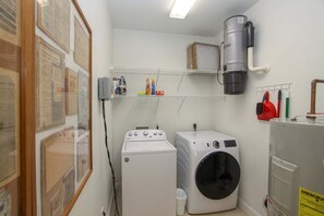 A laundry room with a washing machine, dryer, and a steam iron. - L'escapade, Old Seagrove, Near Seaside, Private Heated Pool, Close to Beach (Seagrove Beach)