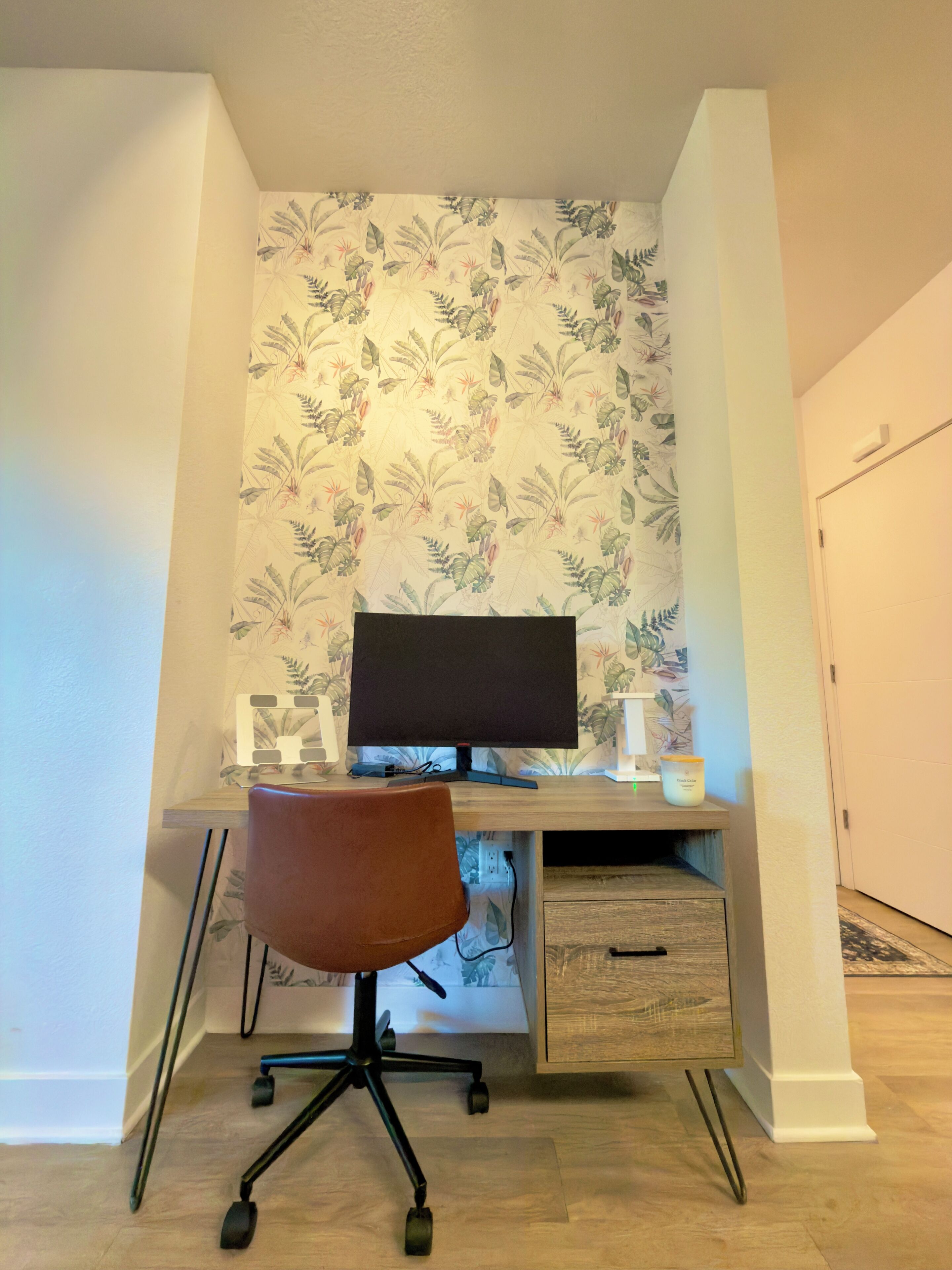 A home office setup with a desk, computer, and chair.
