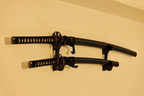 Two black objects with a spiral design, mounted on a beige wall.