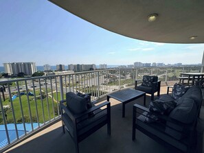 A balcony with a view of a cityscape and the sea. - Coastal Condo with Shared Pools! (Destin)