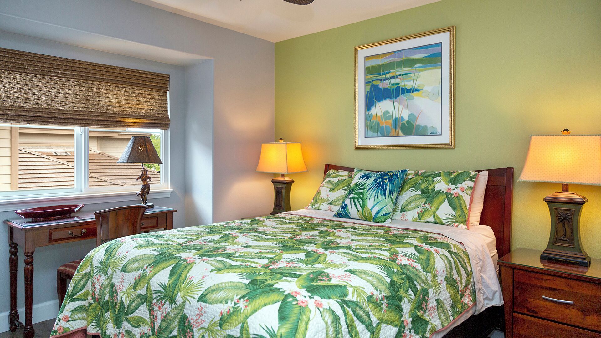 A bedroom with a bed, two bedside tables, a window with blinds, a painting on the wall, and a lamp on each bedside table.