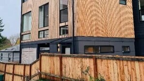 A modern building with a wooden facade and multiple windows. - Delightful Studio apartment with AC in Seattle (Seattle)