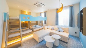 A modern hotel room with a bunk bed, a sofa, two round tables, and a large window with curtains. - Hotel O. Naruto (Naruto)