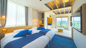 A hotel room with a large bed, a balcony with a view, and a modern ceiling design.