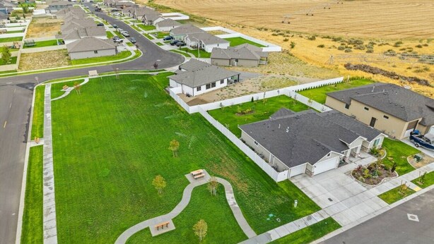 A residential area with houses, a central green space, and a curved driveway. - Spacious 3BR Home + Office | Work & Relax (Boardman)