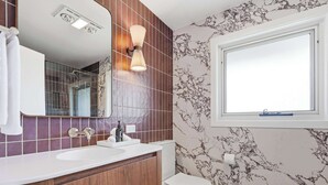 A bathroom with a white sink, a mirror, a toilet, and a window. - Linton, Architect Home Near Mt Panorama (Kelso)