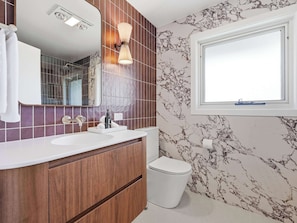 A bathroom with a white sink, a mirror, a toilet, and a window. - Linton, Architect Home Near Mt Panorama (Kelso)