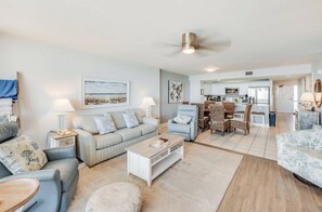 A spacious living room with a sofa, coffee table, and a dining area with chairs. - 3BR at Ocean Bay Club, Pools with Oceanview Condo (North Myrtle Beach)