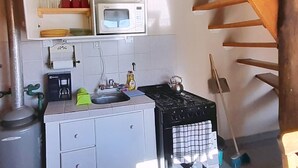 Una cuina senzilla amb microones, rentamicroplats i cafetera.