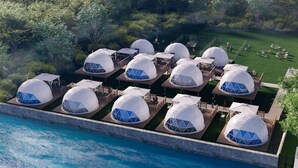 A series of dome-shaped accommodations with outdoor seating areas, surrounded by a landscaped garden and a body of water. - GLAMPREMIER Naruto (Naruto-shi Naruto-cho)
