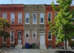 A two-story building with a stone facade and multiple windows. - A modern artsy 3 bedroom/3.5 bathroom townhome in Baltimore AKA Charm City (Baltimore)