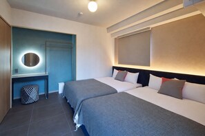 A hotel room with two beds, a desk with a mirror, and a trash bin. - KOUSA Osaka Namba (Osaka)