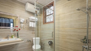 A bathroom with a glass-enclosed shower, a toilet, a sink with a mirror, and a window with decorative bars. - Sapa Fansipan View House (Sa Pa)