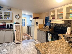 A compact kitchen with a microwave, coffee maker, and a refrigerator. - Nature Cabin Itchetucknee Springs Private Access (Columbia County)