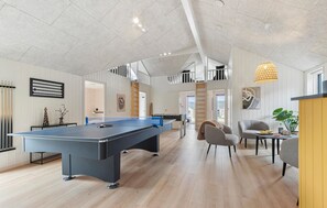 A spacious room with a pool table, a seating area with chairs, and a bright pendant light. - Awesome home in Glesborg with sauna (Glesborg)