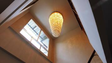 A room with a skylight and a chandelier.