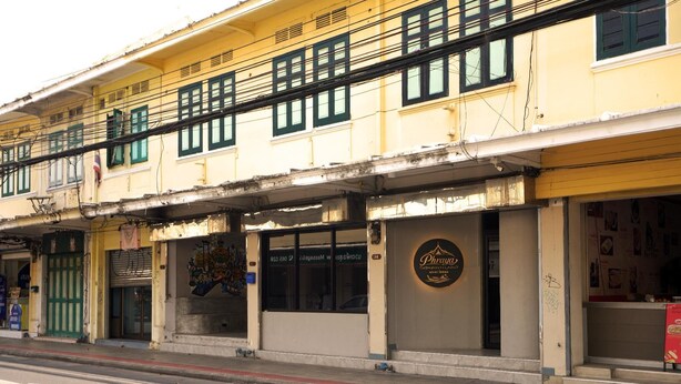 A building with multiple storefronts, including a restaurant named 'Phrya' with a visible sign.