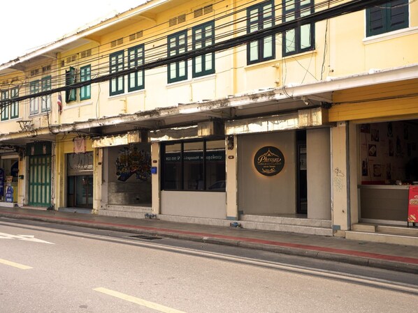 A building with multiple storefronts, including a restaurant named 'Phrya' with a visible sign.