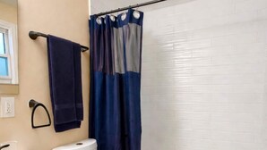 A bathroom with a toilet, sink, and bathtub.