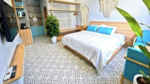 Une chambre à coucher avec un lit, une télévision, un ventilateur de plafond et une plante.