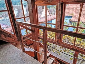 A wooden balcony railing with a view of a town. - Casa Rico by Interhome (Vale)