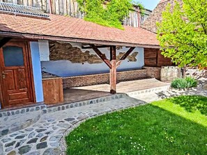 A rustic building with a stone foundation, a wooden door, and a brick wall. - Casa Rico by Interhome (Vale)