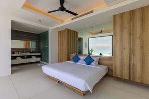 A modern bedroom with a large bed, wooden wardrobe, and a view of the sea. - Blue View Estate by Sublime Samui Villas (Koh Samui)