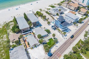 An aerial view of a coastal residential area with houses, a beach, and a road. - Coconut Cottage | Beach Retreat Steps to Sand, Mini Golf & More (Indian Shores)