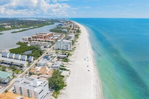 A coastal cityscape with a beachfront, buildings, and a river. - Coconut Cottage | Beach Retreat Steps to Sand, Mini Golf & More (Indian Shores)
