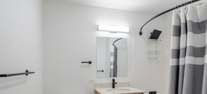 A modern bathroom with a shower, a toilet, a sink, and a mirror. - Blueground | Denny Triangle, gym, nr Seattle Art Museum (Seattle)