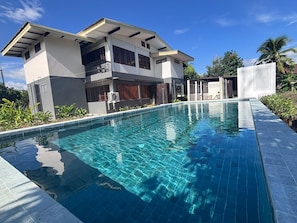 A modern two-story house with a swimming pool.