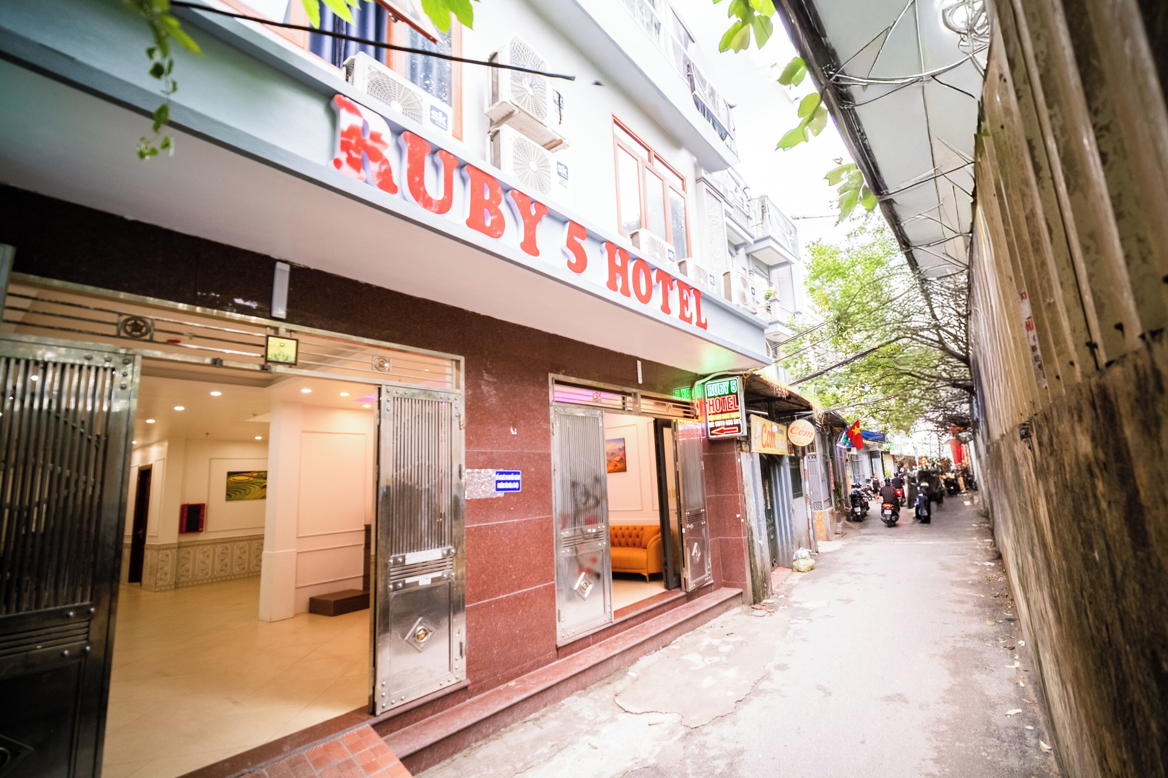 A hotel with a sign reading 'Ruby's Hotel' and a visible entrance.