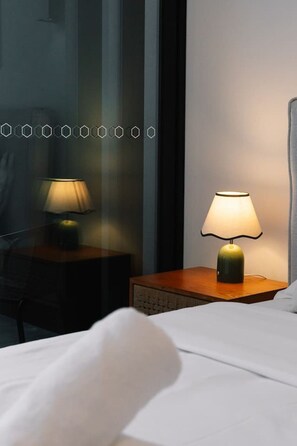A hotel room with a bed, a nightstand with a lamp, and a chair. - Luxury 1BR with Stunning Ocean Views (Broadbeach)