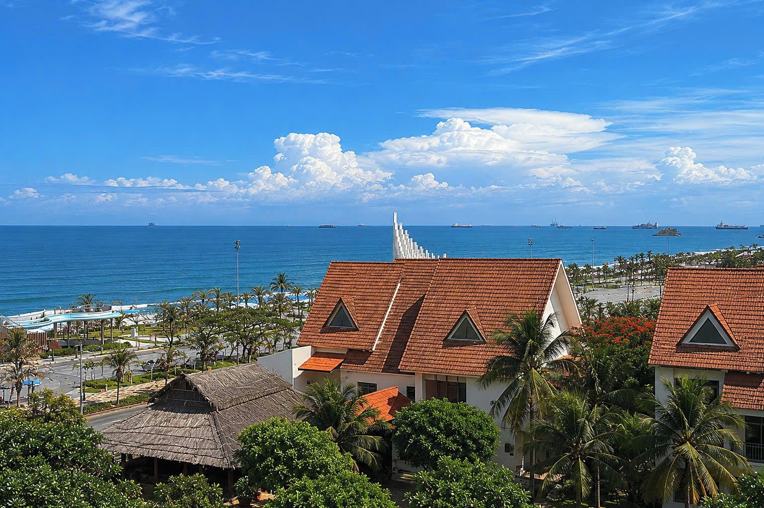 A coastal view with buildings, a clear sky, and the ocean.