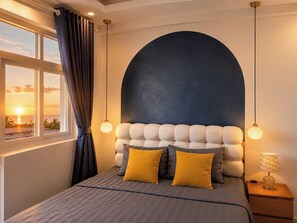 Un dormitorio con cama, ventana con cortinas, mesita de noche con lámpara y pared decorada con un diseño circular grande.