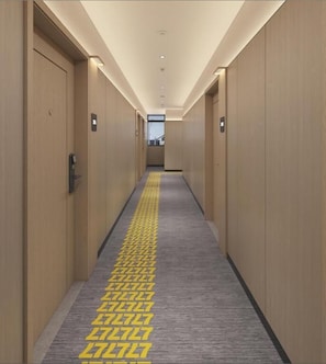 A hotel hallway with wooden doors, a patterned carpet, and a light-colored floor. - 7 Days Premium Hotel Hang Lekiu (Kuala Lumpur)