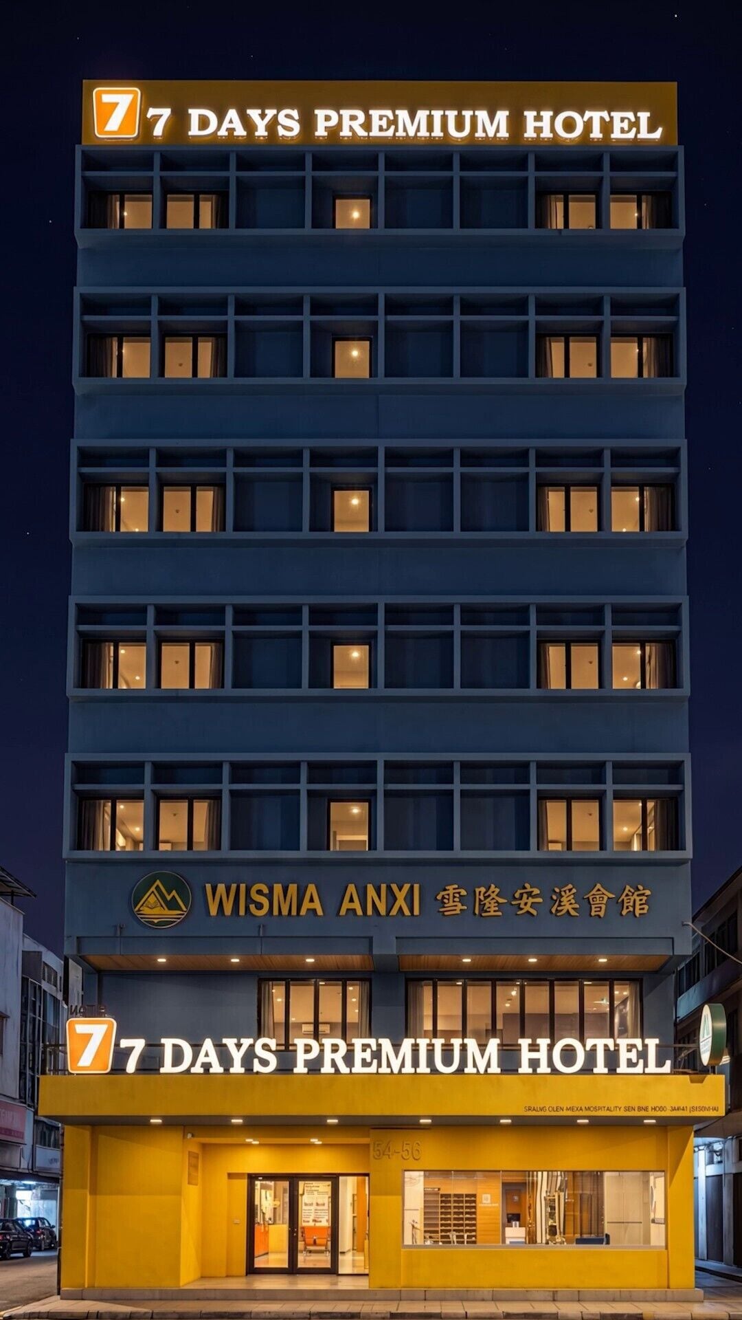 A multi-story hotel with a prominent sign reading '7 DAYS PREMIUM HOTEL'.