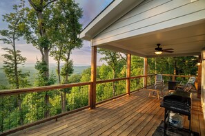 A wooden deck with a view of a forest and mountains. - Mountain Views Retreat | Retreat for 2 | Breathtaking Scenery | Firepit (Clarkesville)