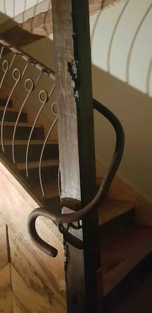 A wooden staircase with metal handrails.