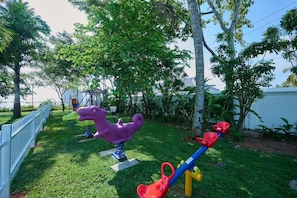 A playground with a seesaw and a dinosaur-shaped swing set. - Gokulam Grand Resort and Spa Kumarakom (Kottayam)