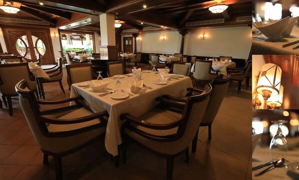 A restaurant with round tables set for dining, chairs, and overhead lighting. - Gokulam Grand Resort and Spa Kumarakom (Kottayam)