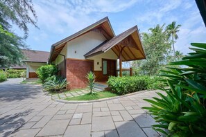 A two-story building with a sloped roof, a covered porch, and a paved driveway. - Gokulam Grand Resort and Spa Kumarakom (Kottayam)