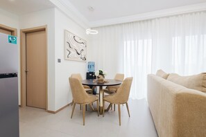 A modern living room with a dining area, a sofa, and a water dispenser. - City views (Nairobi)