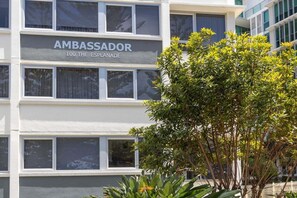 A multi-story building with the sign 'AMBASSADOR 100 THE ESPLANADE' indicating a hotel or similar establishment. - Ambassador Beachfront Burleigh Heads (Gold Coast)