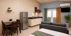 A compact living space with a kitchenette, a dining area, and a sofa. - Cozy Curaçao Studio for 4 with AC & Private Patio (willemstad)