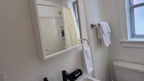 A bathroom with a white sink, a mirror, a towel rack, and a toilet. - Relocate to the Loop • Quiet 2BR near WashU 1N (University City)